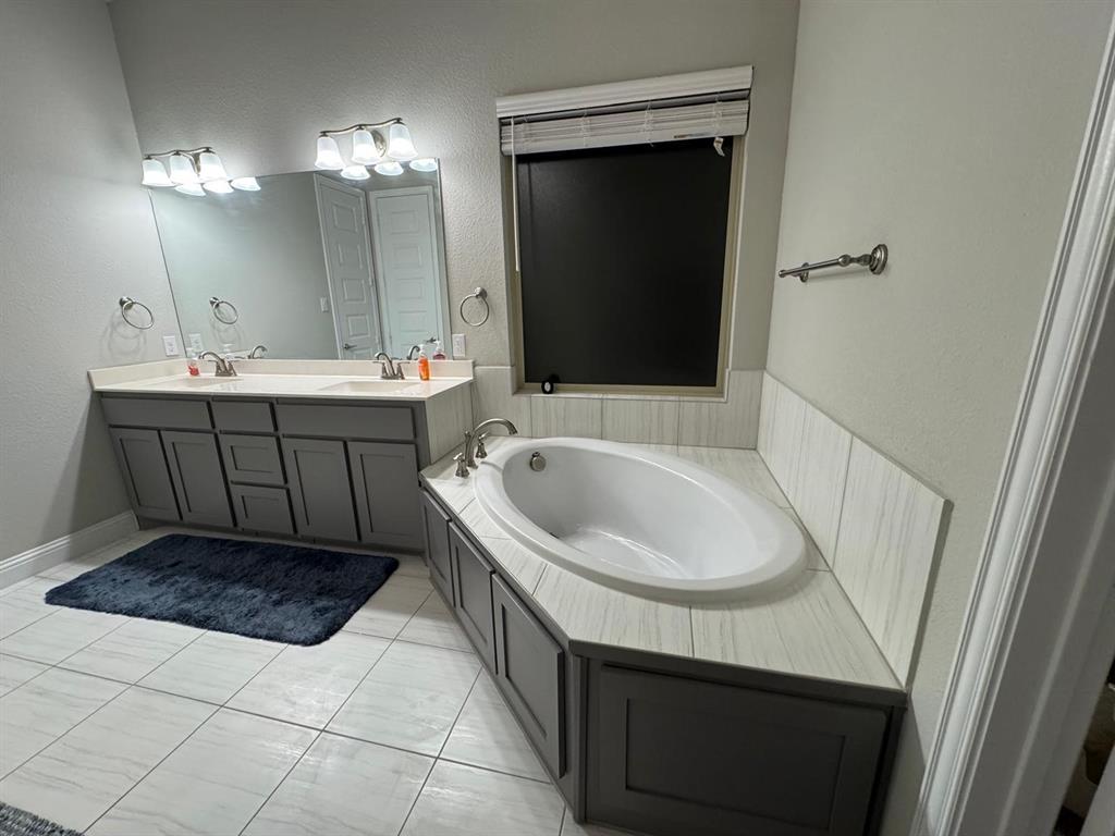 1204 Sundrop Drive Little Elm, TX 75068 - Photo 14 of 24 a bathroom with a sink and a mirror