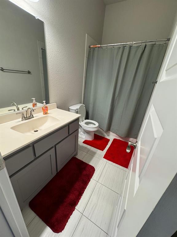 1204 Sundrop Drive Little Elm, TX 75068 - Photo 15 of 24 a bathroom with a sink and a mirror