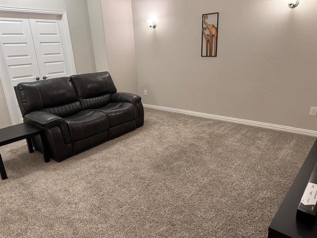 1204 Sundrop Drive Little Elm, TX 75068 - Photo 22 of 24 a living room with furniture and a window