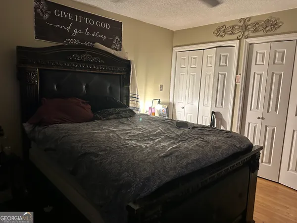 a bedroom with a bed and a fireplace