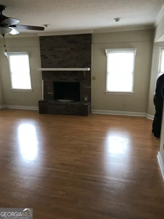 a view of empty room with window and fireplace