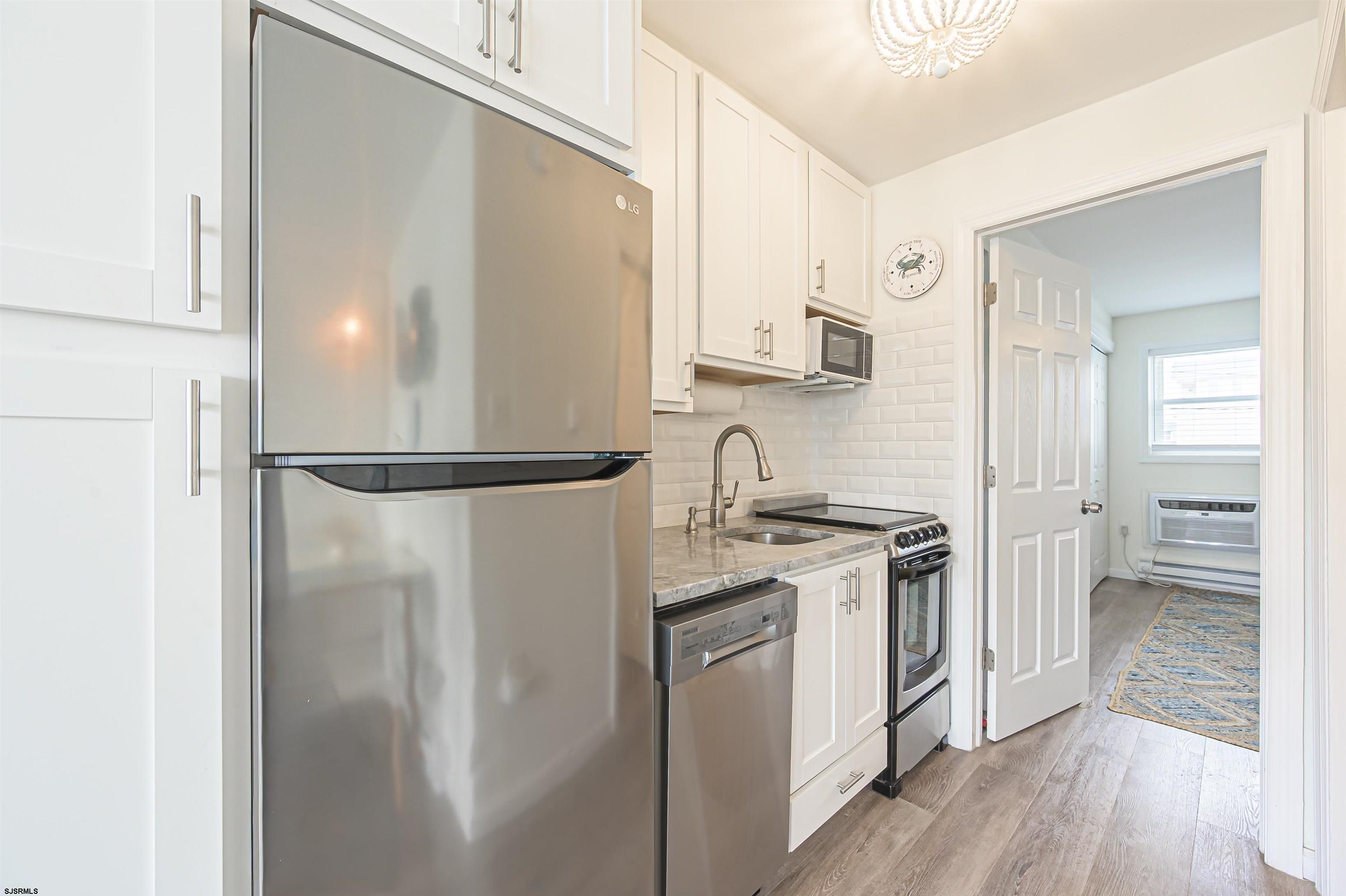 413 East Brigantine Avenue, Unit 38 Brigantine, NJ 08203 - Photo 7 of 11 a kitchen with stainless steel appliances granite countertop a refrigerator and a sink
