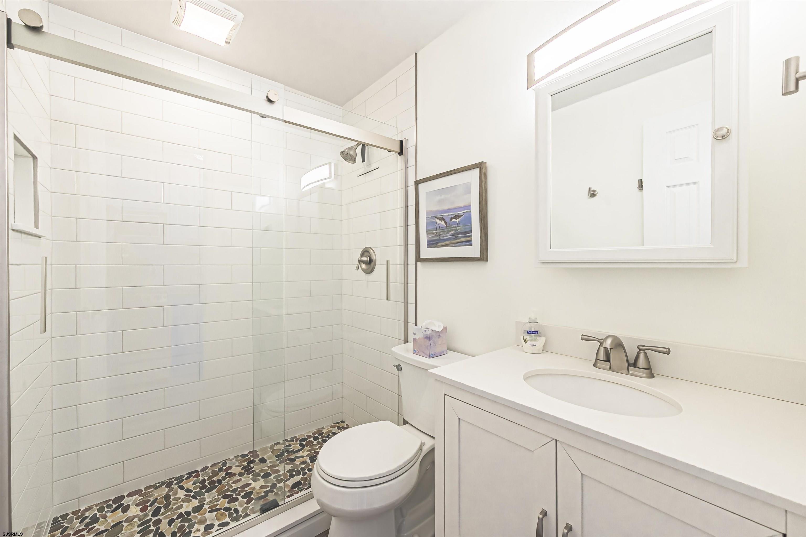 413 East Brigantine Avenue, Unit 38 Brigantine, NJ 08203 - Photo 10 of 11 a bathroom with a sink a toilet and shower