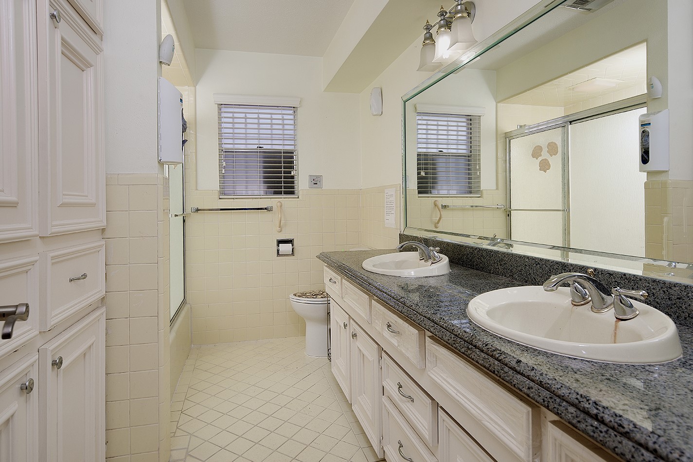 23218 Aldine Westfield Road Spring, TX 77373 - Photo 18 of 47 a bathroom with a granite countertop sink a mirror and a toilet