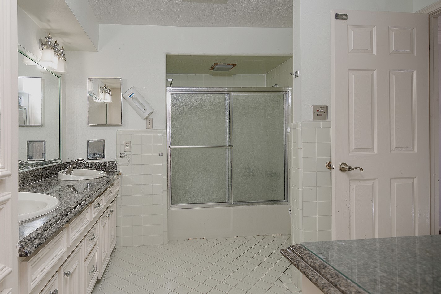 23218 Aldine Westfield Road Spring, TX 77373 - Photo 20 of 47 a spacious bathroom with a granite countertop sink a mirror and shower