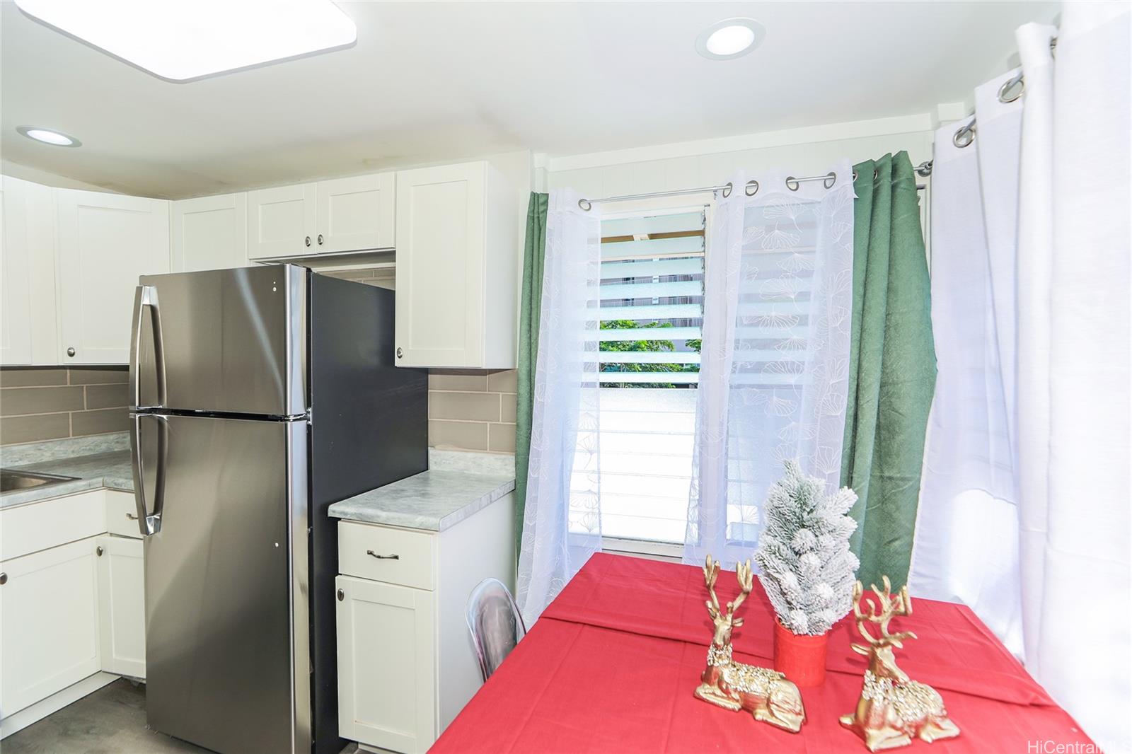 1641 Stillman Lane Honolulu, HI 96817 - Photo 5 of 25 a bedroom with a bed and a refrigerator