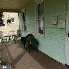 a backyard of a house with outdoor seating