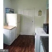 a hallway with a refrigerator a washer and dryer