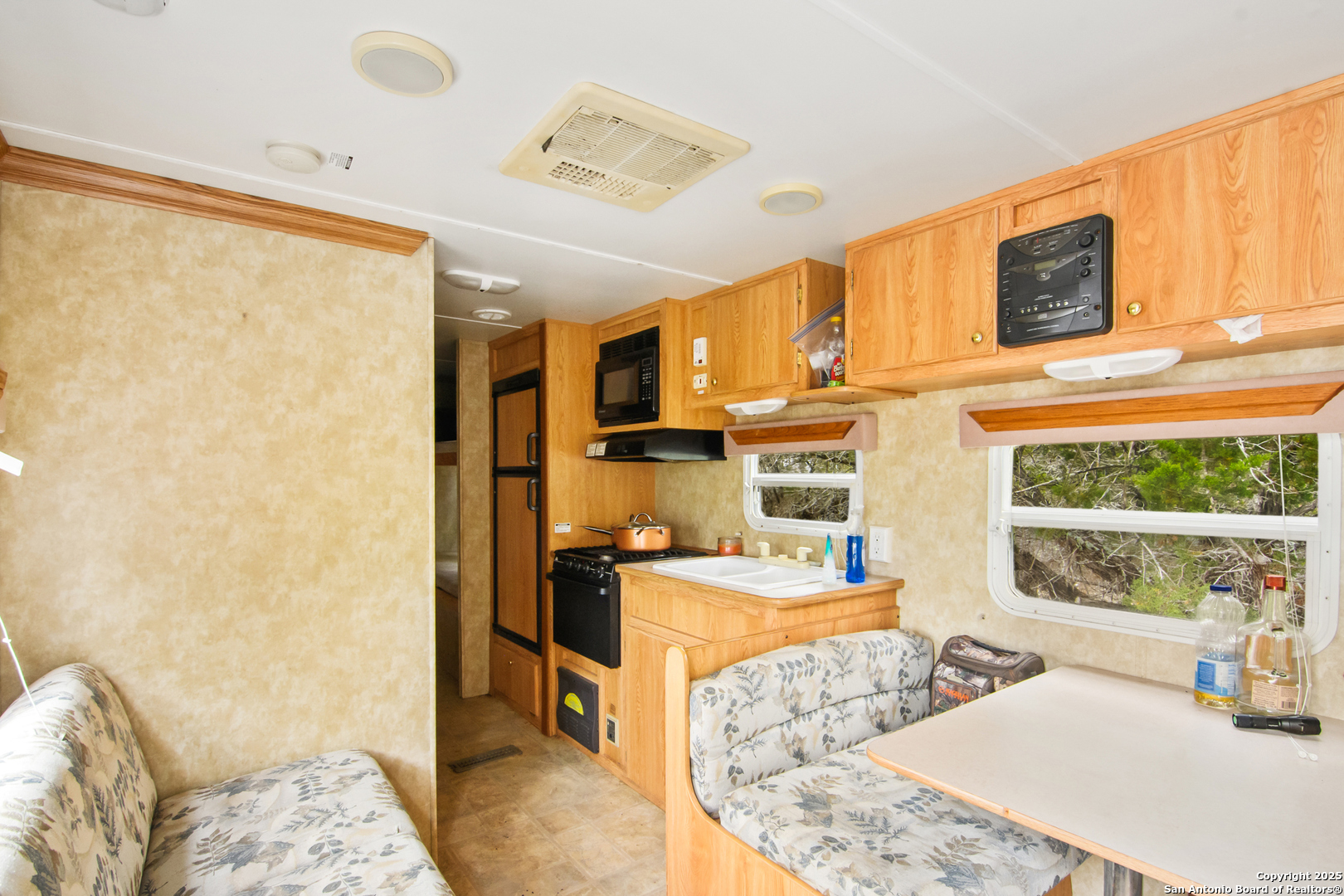 87 Mutt Road Brackettville, TX 78832 - Photo 4 of 20 a living room with stainless steel appliances kitchen island granite countertop furniture and a rug