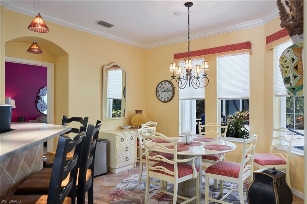 20540 Rookery Drive Estero, FL 33928 - Photo 6 of 32 a view of a dining room with furniture window and wooden floor