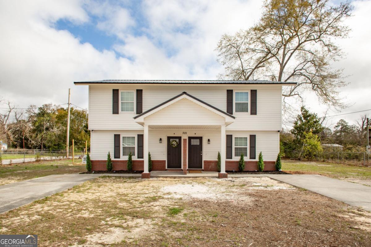 301 Fireman Street, Unit B Waycross, GA 31503 - Photo 1 of 1 a view of a house with backyard and trees