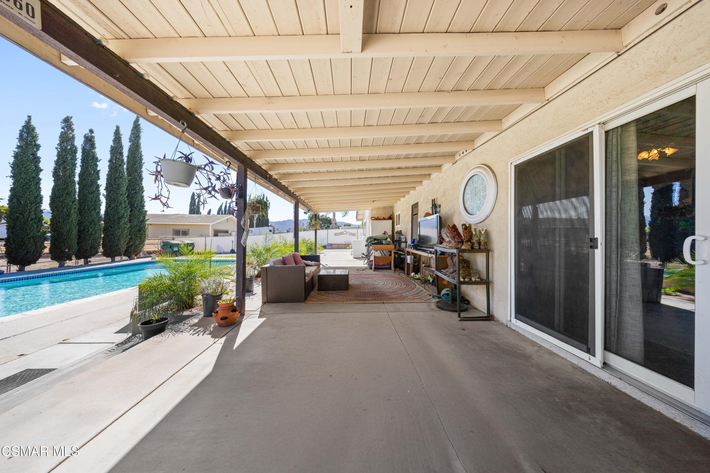4931 Roundup Road Norco, CA 92860 - Photo 13 of 21 a view of a patio with table and chairs and a large tree