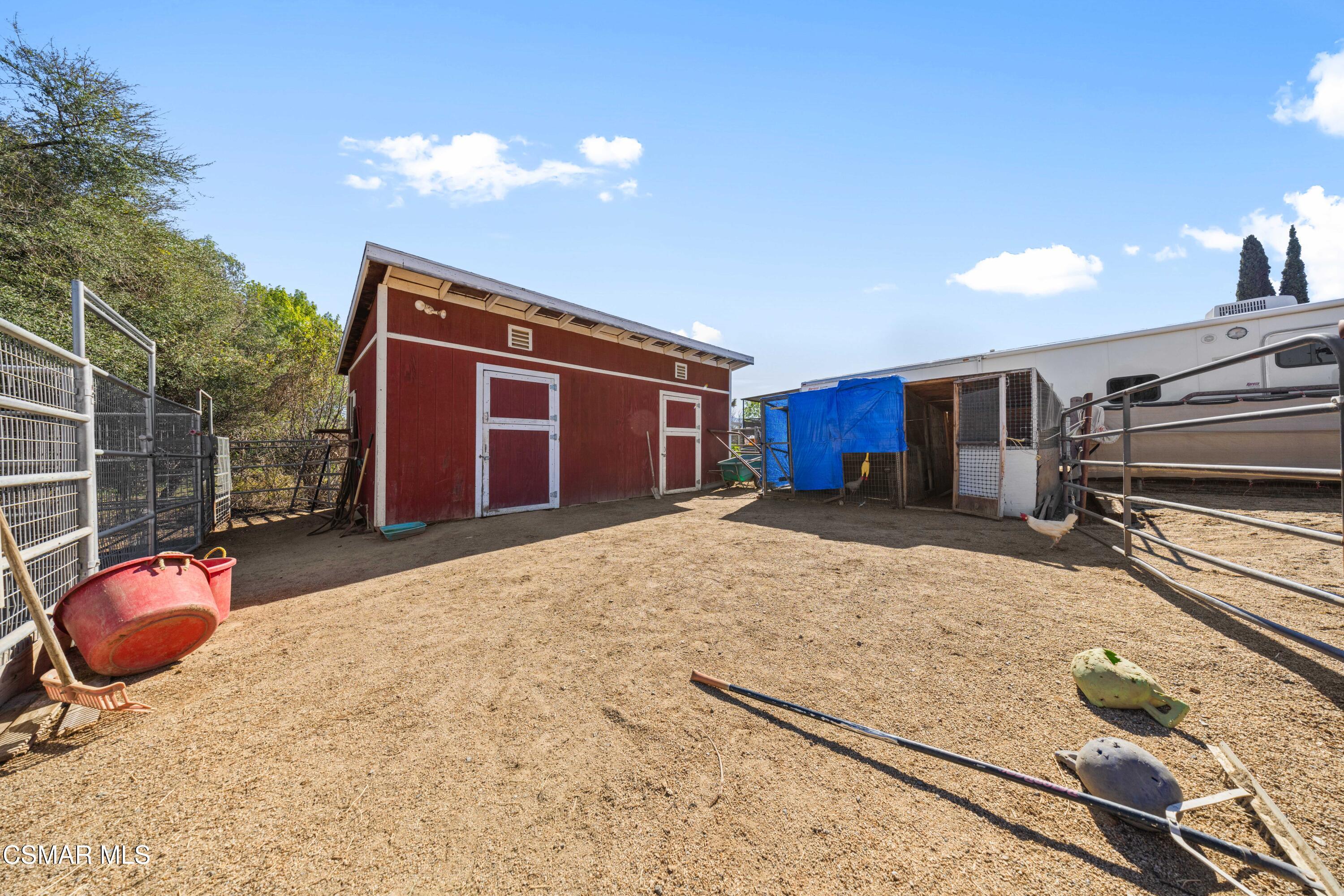 4931 Roundup Road Norco, CA 92860 - Photo 21 of 21 a bedroom with a bed and a chandelier