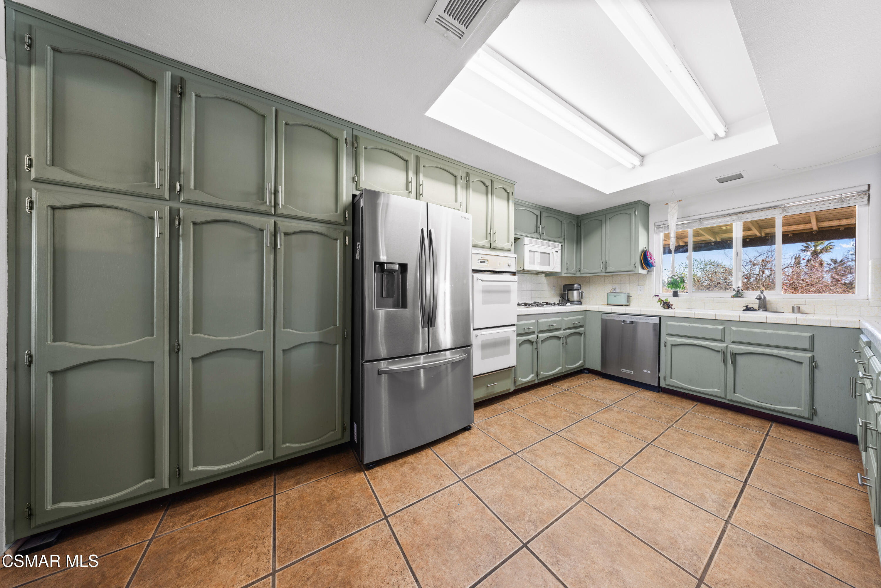 4931 Roundup Road Norco, CA 92860 - Photo 4 of 21 a kitchen with a refrigerator sink and cabinets