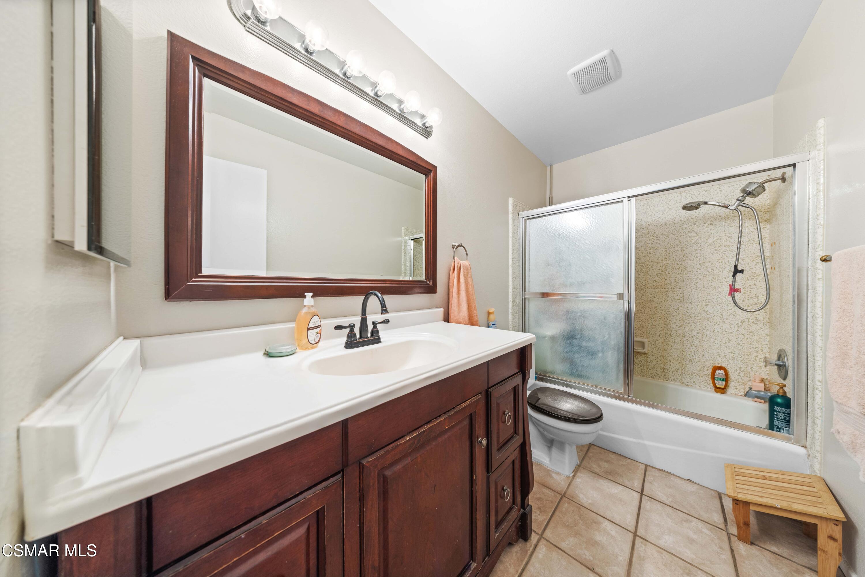 4931 Roundup Road Norco, CA 92860 - Photo 9 of 21 a bathroom with a sink a toilet a mirror and shower