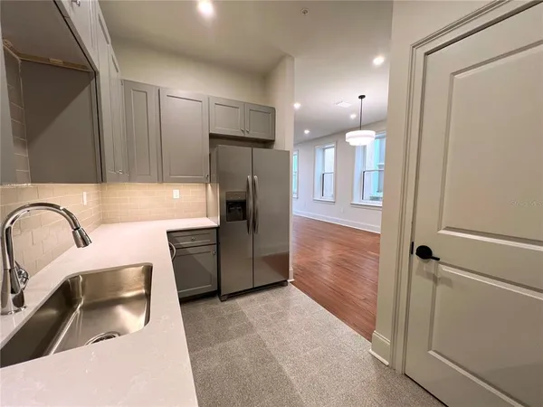 an empty room with a empty space and a ceiling fan