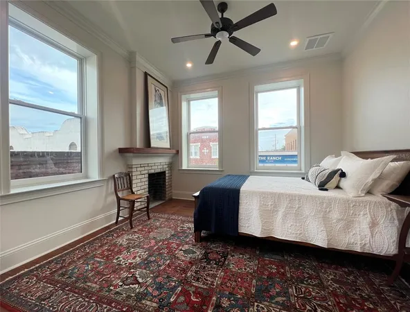 a view of a room with a ceiling fan and window