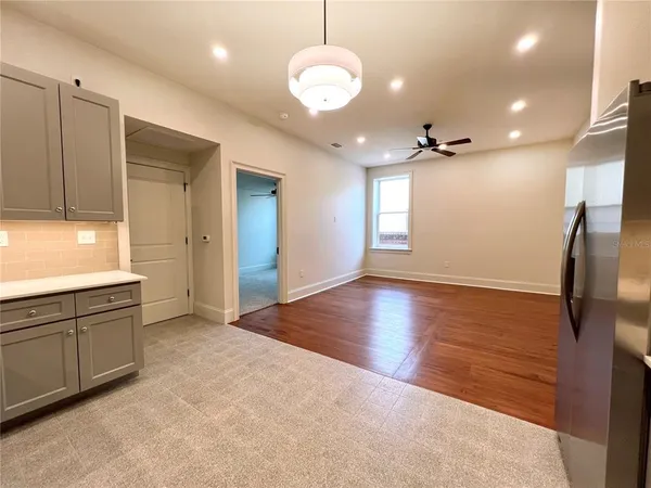 a dining room with furniture and a chandelier