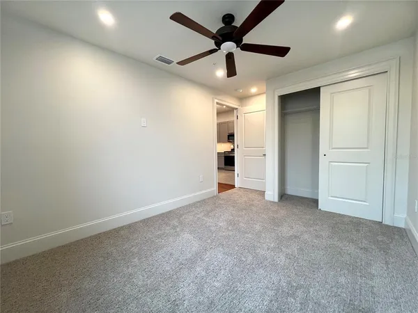 a view of a dining room with furniture a chandelier and wooden floor