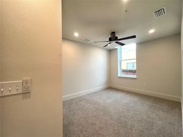 a view of a livingroom with wooden floor and a large window