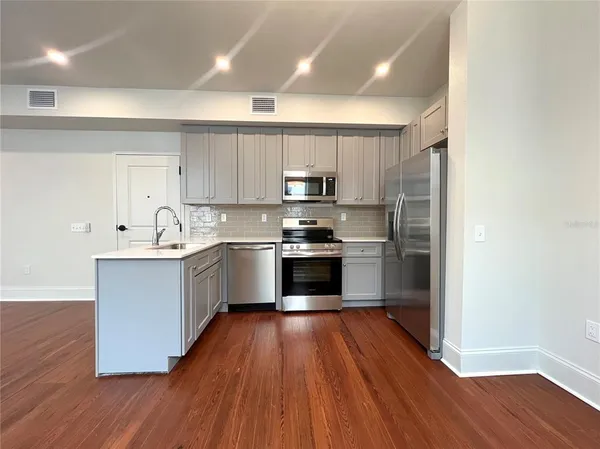 a view of hallway with wooden floor