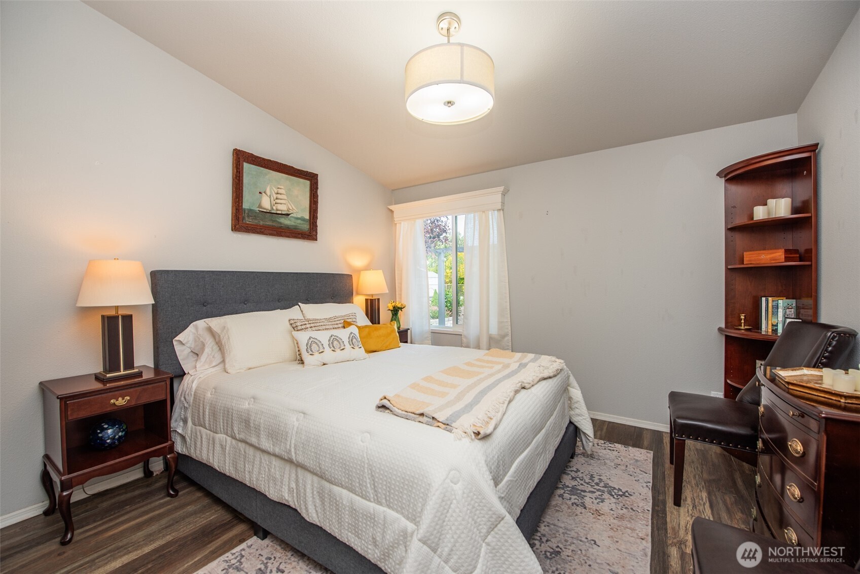 720 West Heritage Loop Sequim, WA 98382 - Photo 25 of 35 a bedroom with a bed and a lamp on table