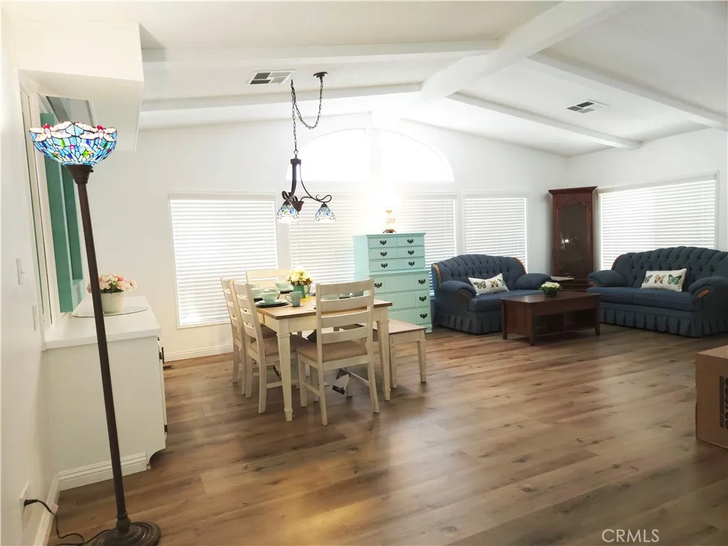 840 Foothill, Unit 203 Azusa, CA 91702 - Photo 12 of 21 a view of a livingroom with furniture wooden floor and a chandelier