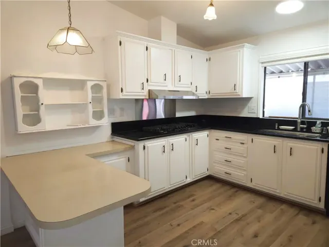a kitchen with granite countertop white cabinets and white appliances