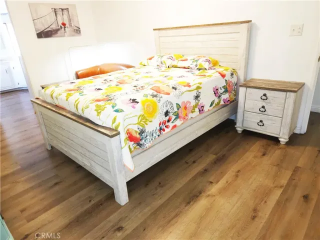 a bed sitting in a bedroom next to a window