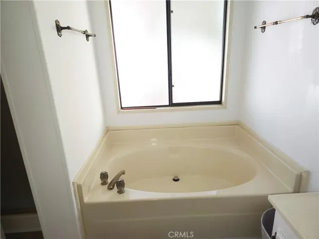 a white bath tub sitting next to a window