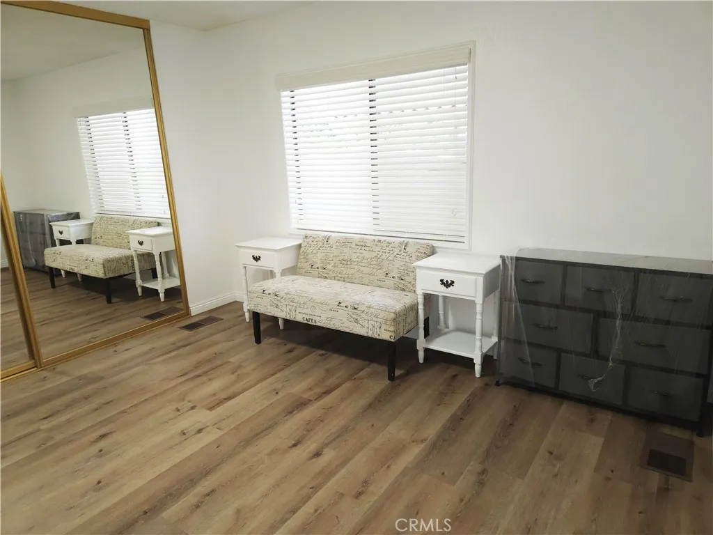 840 Foothill, Unit 203 Azusa, CA 91702 - Photo 10 of 21 a living room with furniture and a wooden floor