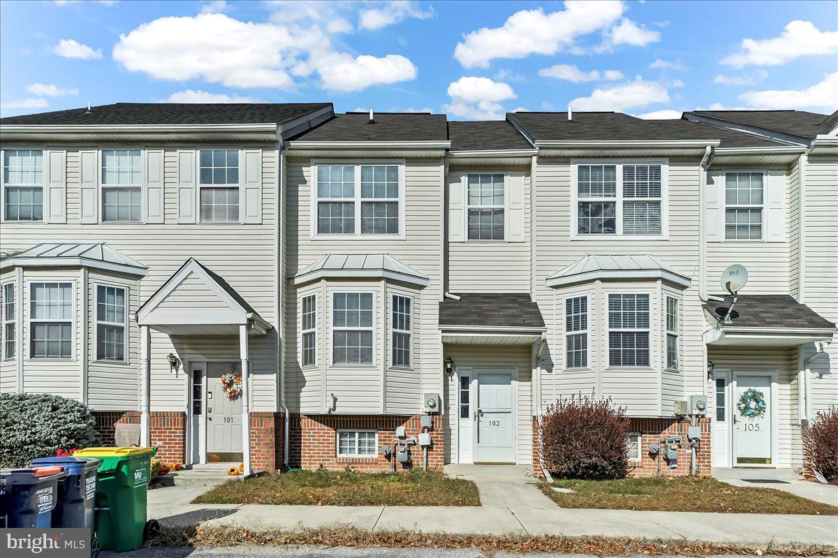 a front view of a house with a yard outdoor seating and barbeque oven