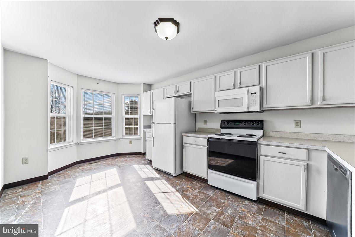 103 Bonnybrook Road Middletown, DE 19709 - Photo 7 of 32 a kitchen with stainless steel appliances granite countertop a stove a sink and a refrigerator