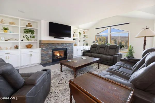 a living room with furniture fireplace and flat screen tv