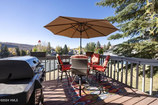 a view of a balcony with furniture and umbrella
