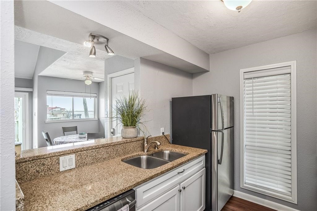 14300 Aloha Street, Unit 231 Corpus Christi, TX 78418 - Photo 11 of 37 a kitchen with a refrigerator and a sink