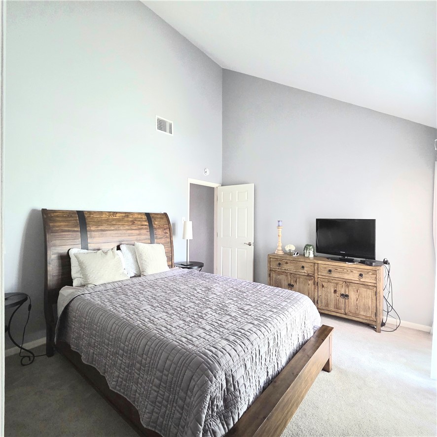 14300 Aloha Street, Unit 231 Corpus Christi, TX 78418 - Photo 14 of 37 a bedroom with a bed and a flat screen tv