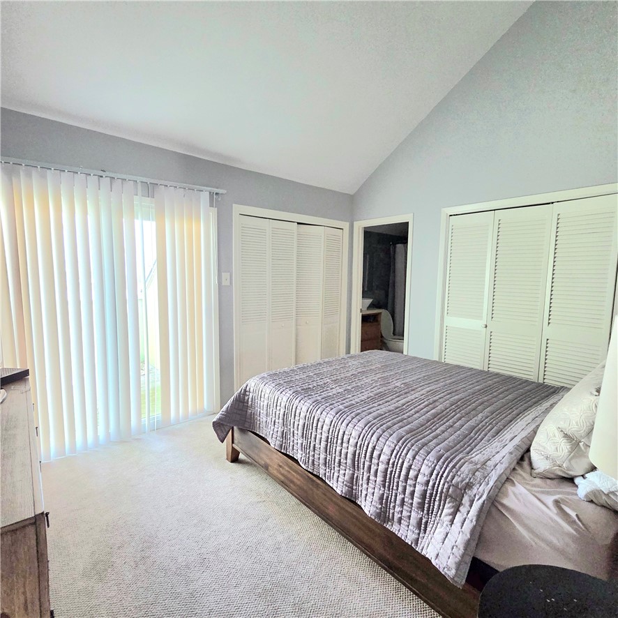 14300 Aloha Street, Unit 231 Corpus Christi, TX 78418 - Photo 15 of 37 a bed sitting in a spacious bedroom next to a window and a bathroom