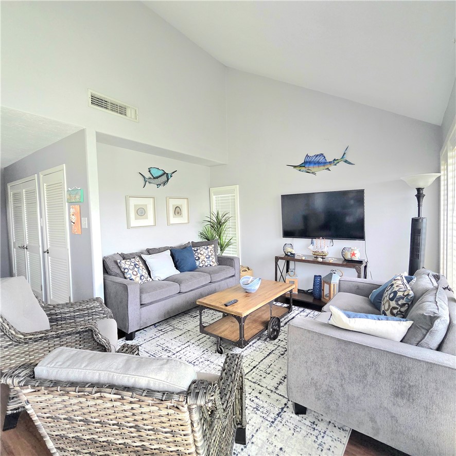 14300 Aloha Street, Unit 231 Corpus Christi, TX 78418 - Photo 5 of 37 a living room with furniture and a flat screen tv