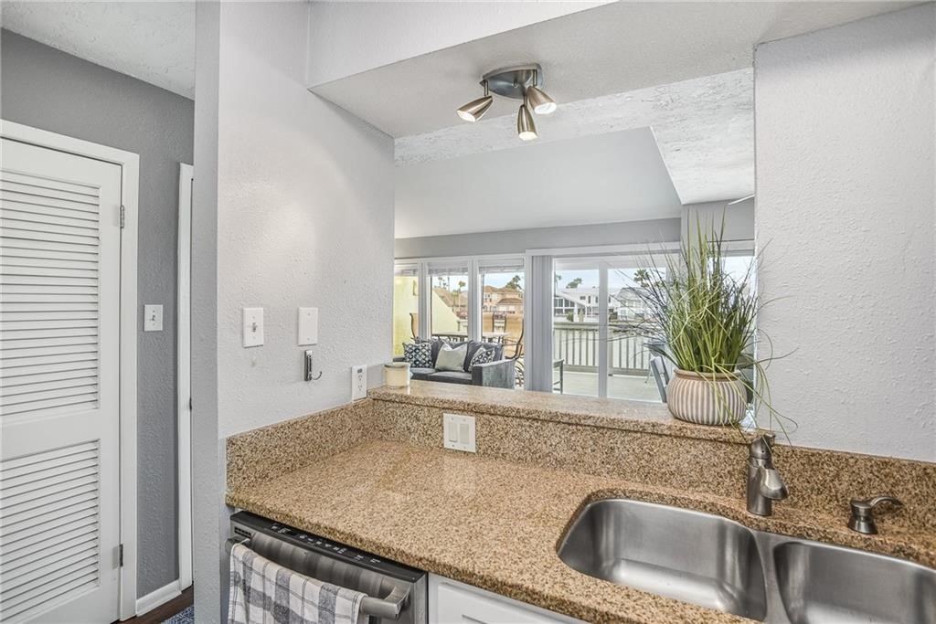 14300 Aloha Street, Unit 231 Corpus Christi, TX 78418 - Photo 10 of 37 a kitchen with a sink and a granite counter top