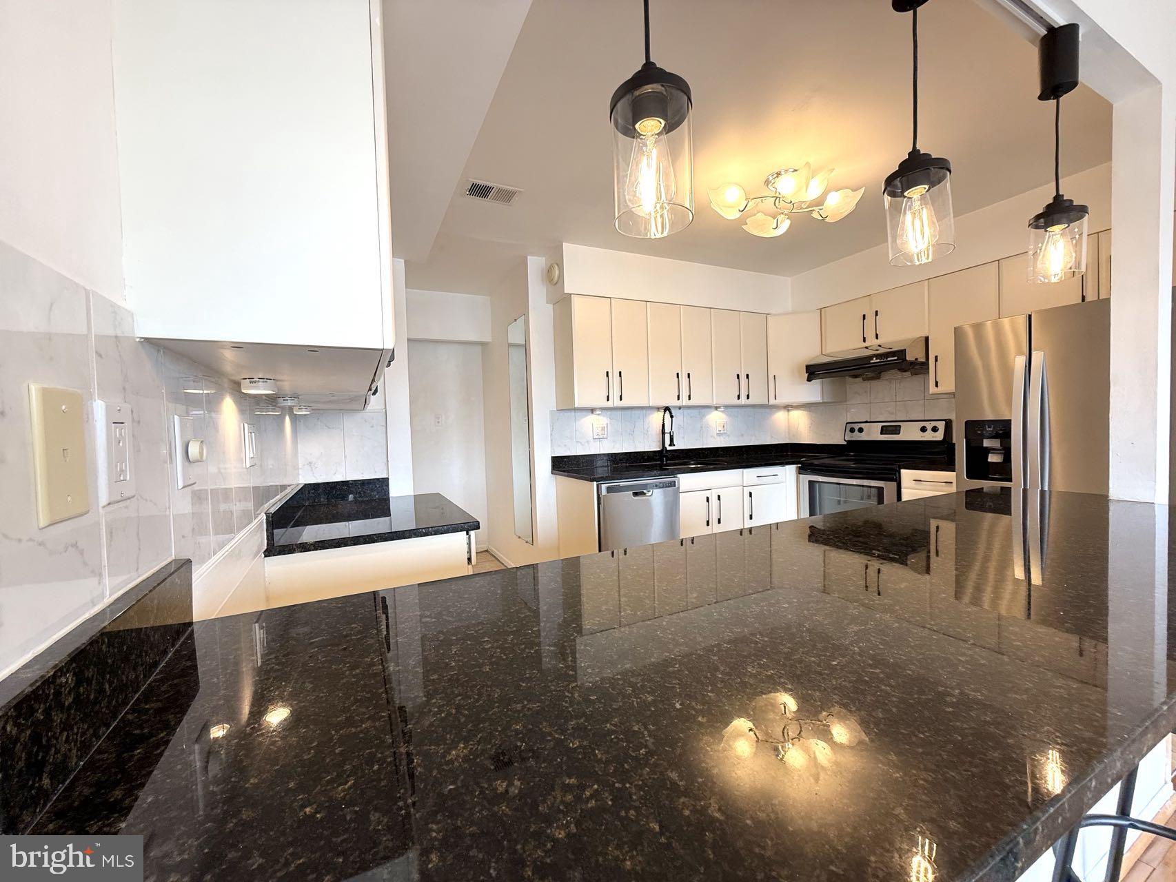 532 Riviera Drive, Unit 532B Joppa, MD 21085 - Photo 11 of 44 a kitchen with stainless steel appliances granite countertop a stove a sink and a refrigerator