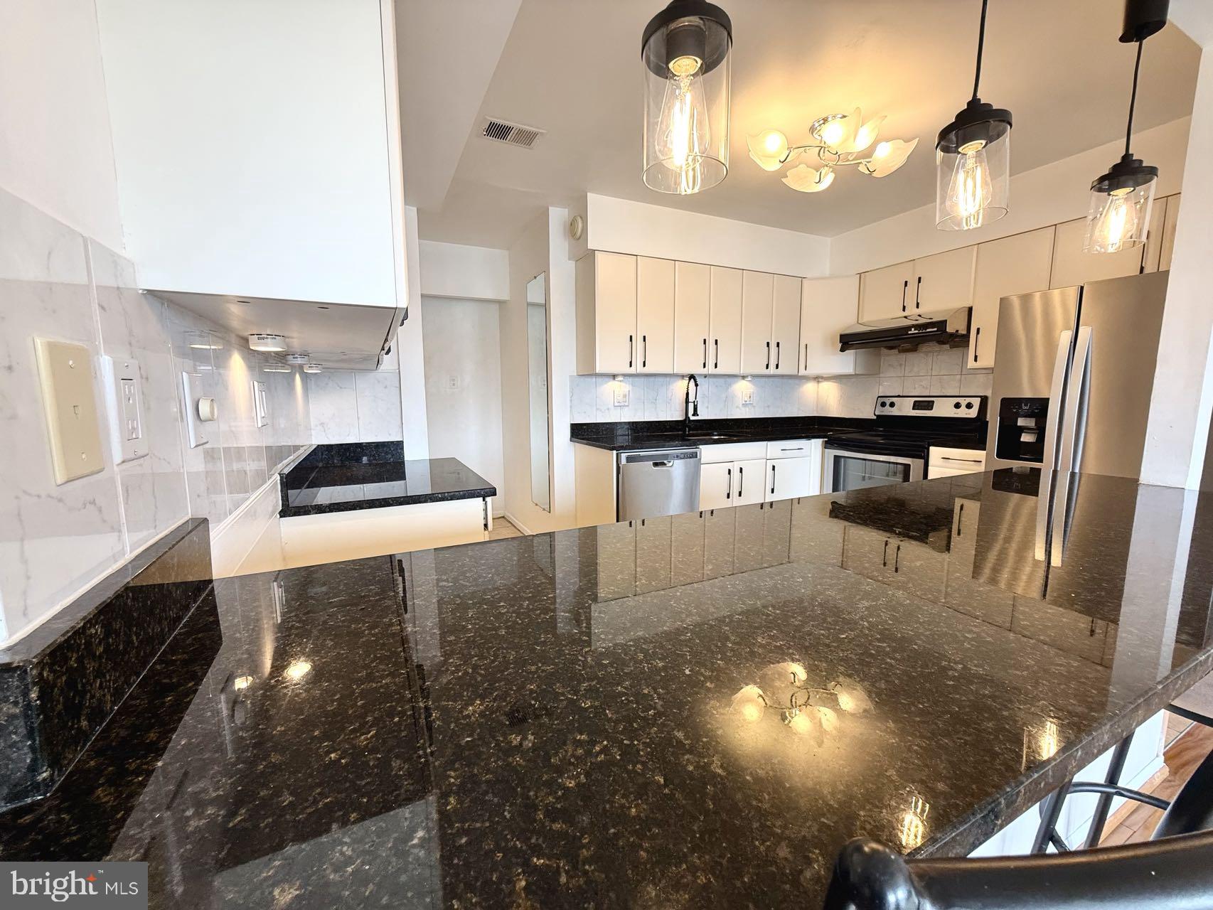 532 Riviera Drive, Unit 532B Joppa, MD 21085 - Photo 12 of 43 a kitchen with stainless steel appliances granite countertop a sink a stove and a refrigerator