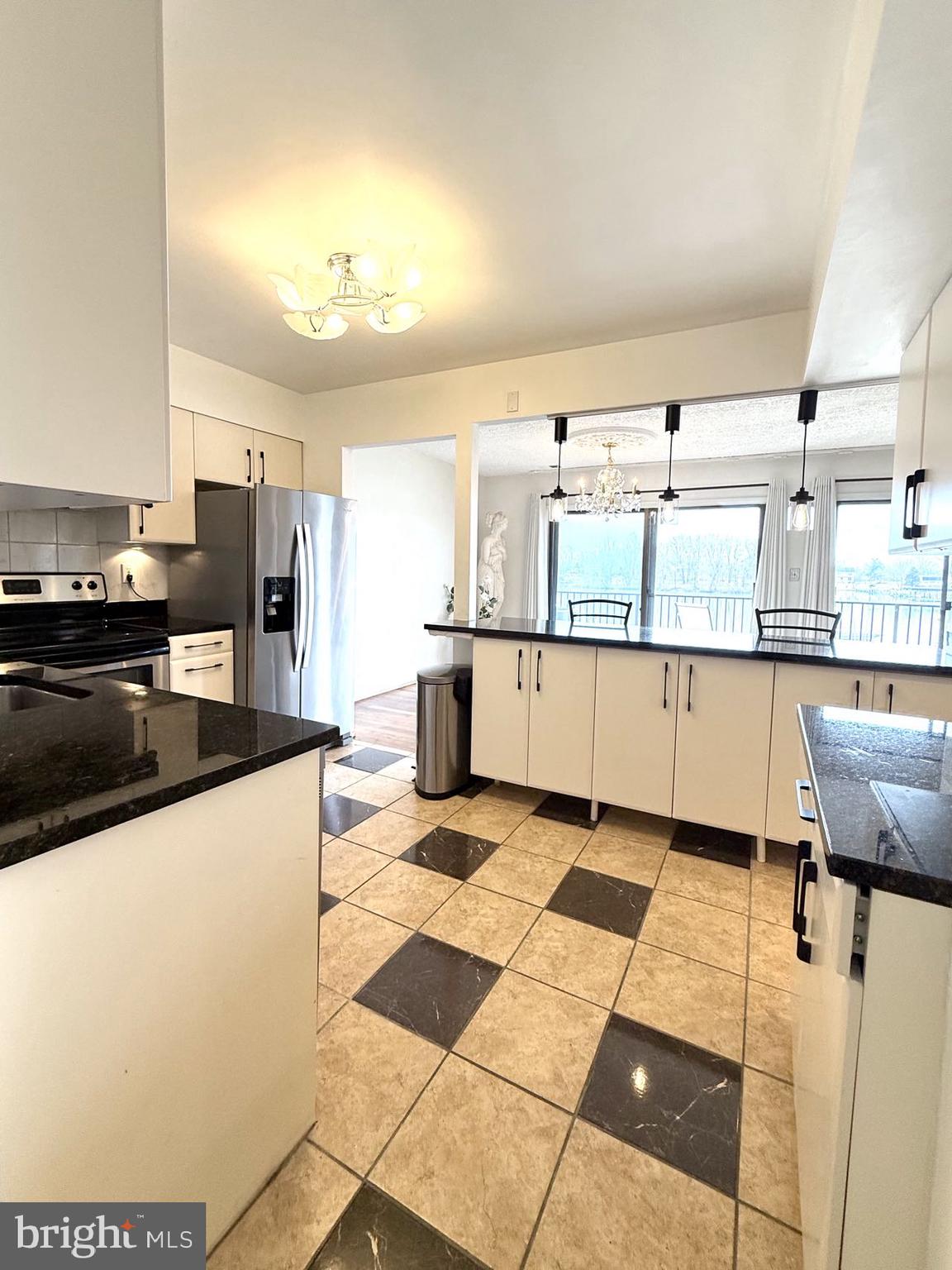 532 Riviera Drive, Unit 532B Joppa, MD 21085 - Photo 13 of 43 a kitchen with stainless steel appliances granite countertop a sink and cabinets