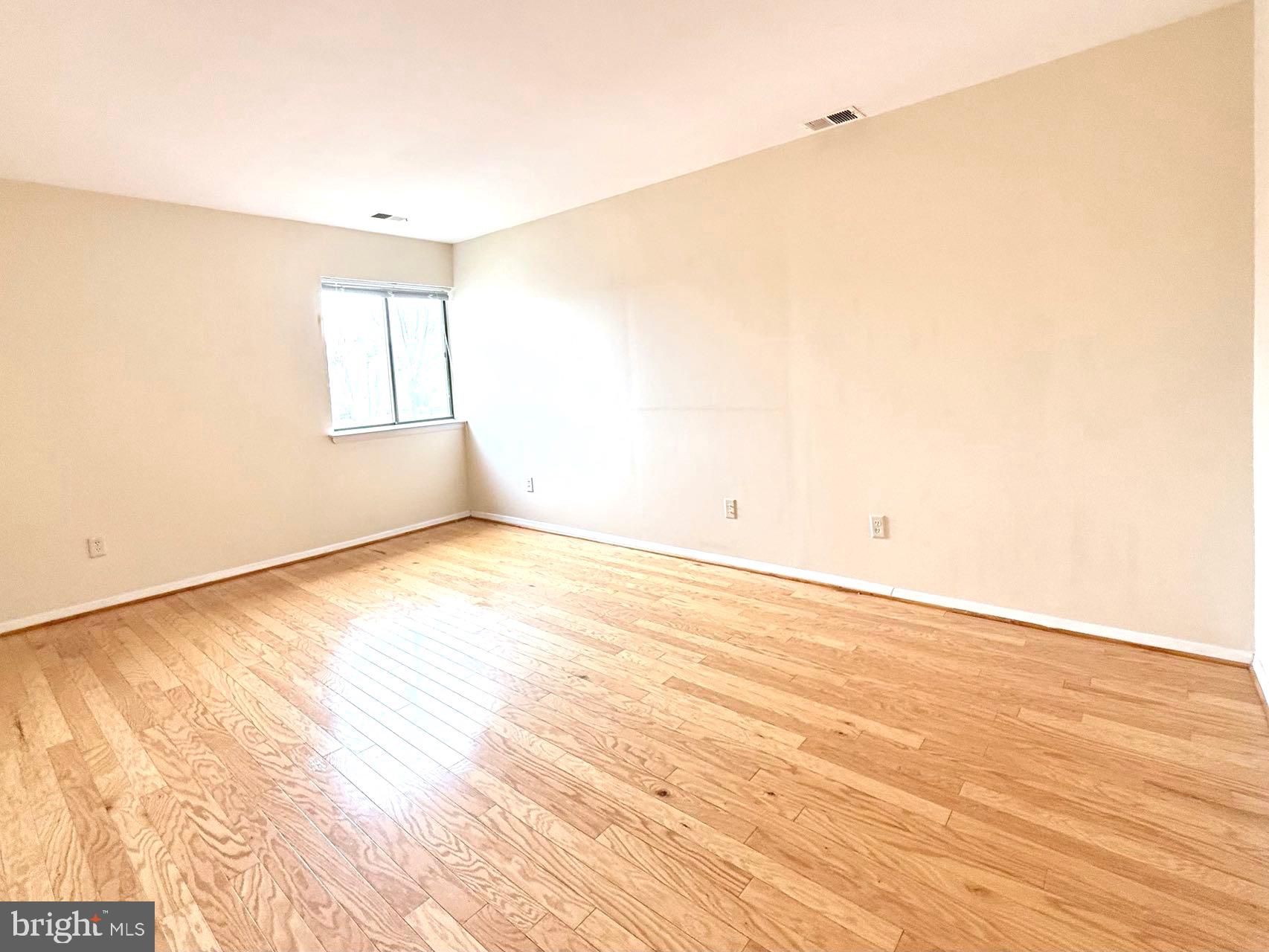 532 Riviera Drive, Unit 532B Joppa, MD 21085 - Photo 20 of 44 an empty room with wooden floor and windows
