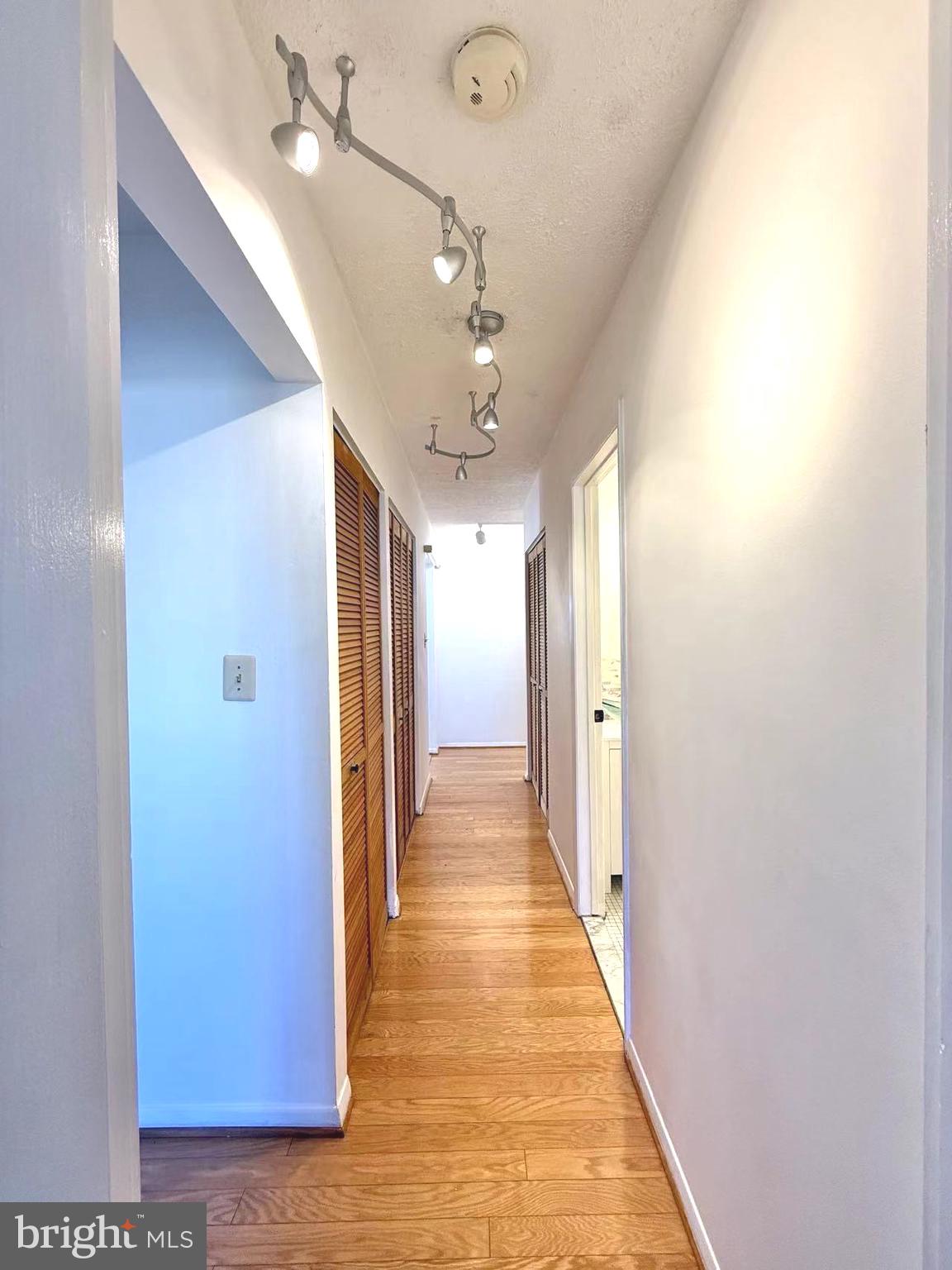 532 Riviera Drive, Unit 532B Joppa, MD 21085 - Photo 26 of 43 a view of a hallway with wooden floor and chandelier