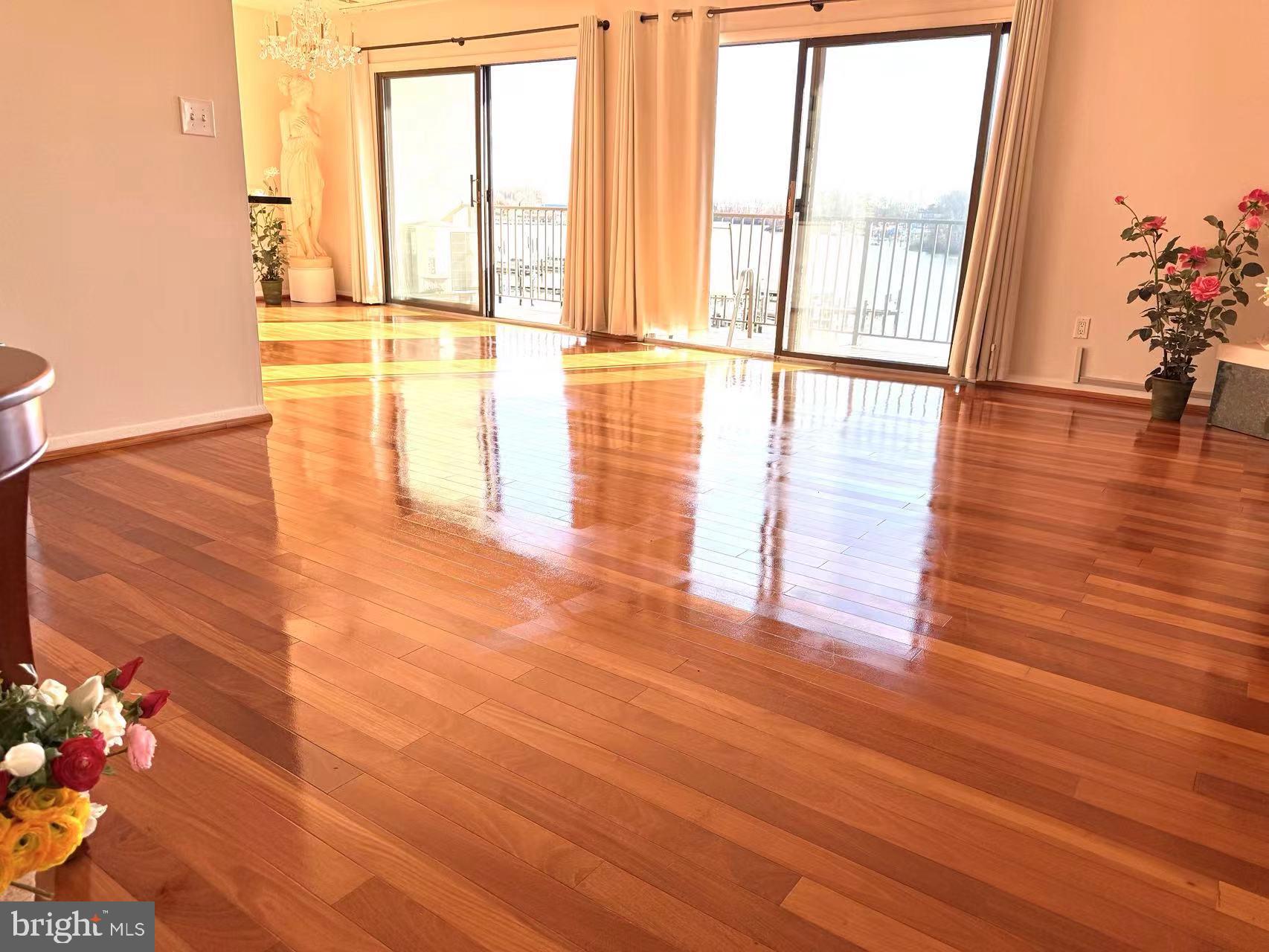 532 Riviera Drive, Unit 532B Joppa, MD 21085 - Photo 6 of 43 a view of an empty room with wooden floor and a floor to ceiling window