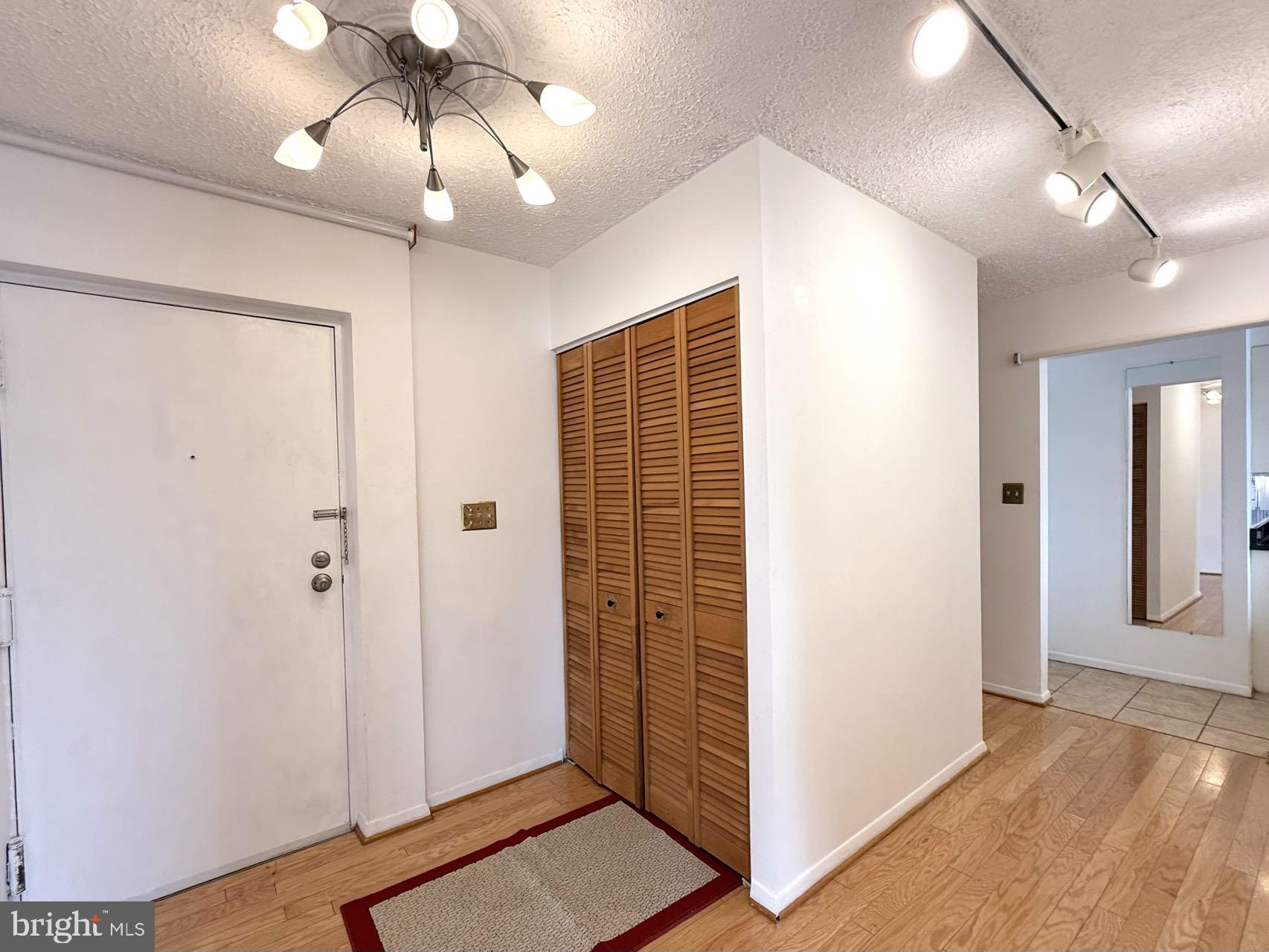 532 Riviera Drive, Unit 532B Joppa, MD 21085 - Photo 6 of 44 a view of a hallway with wooden floor and chandelier
