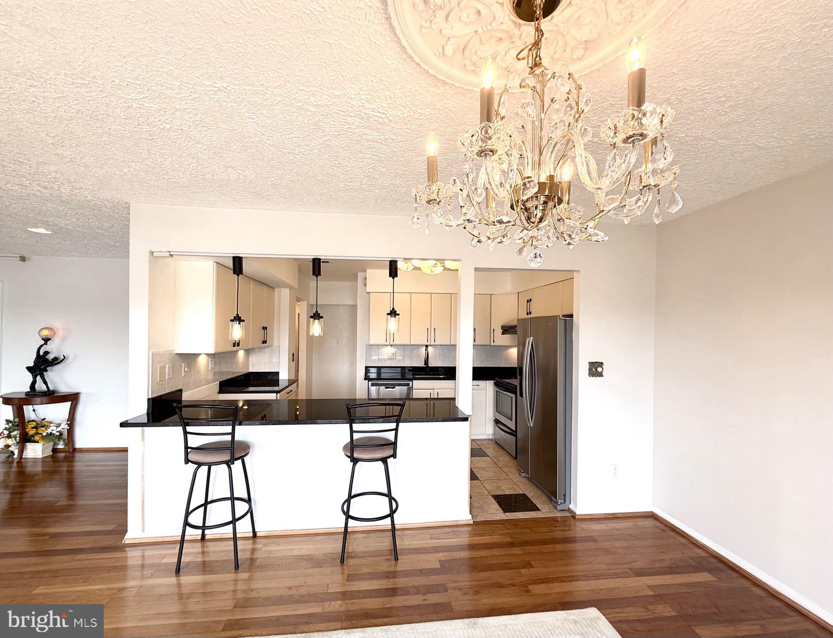 532 Riviera Drive, Unit 532B Joppa, MD 21085 - Photo 9 of 43 a living room with fireplace furniture and a chandelier