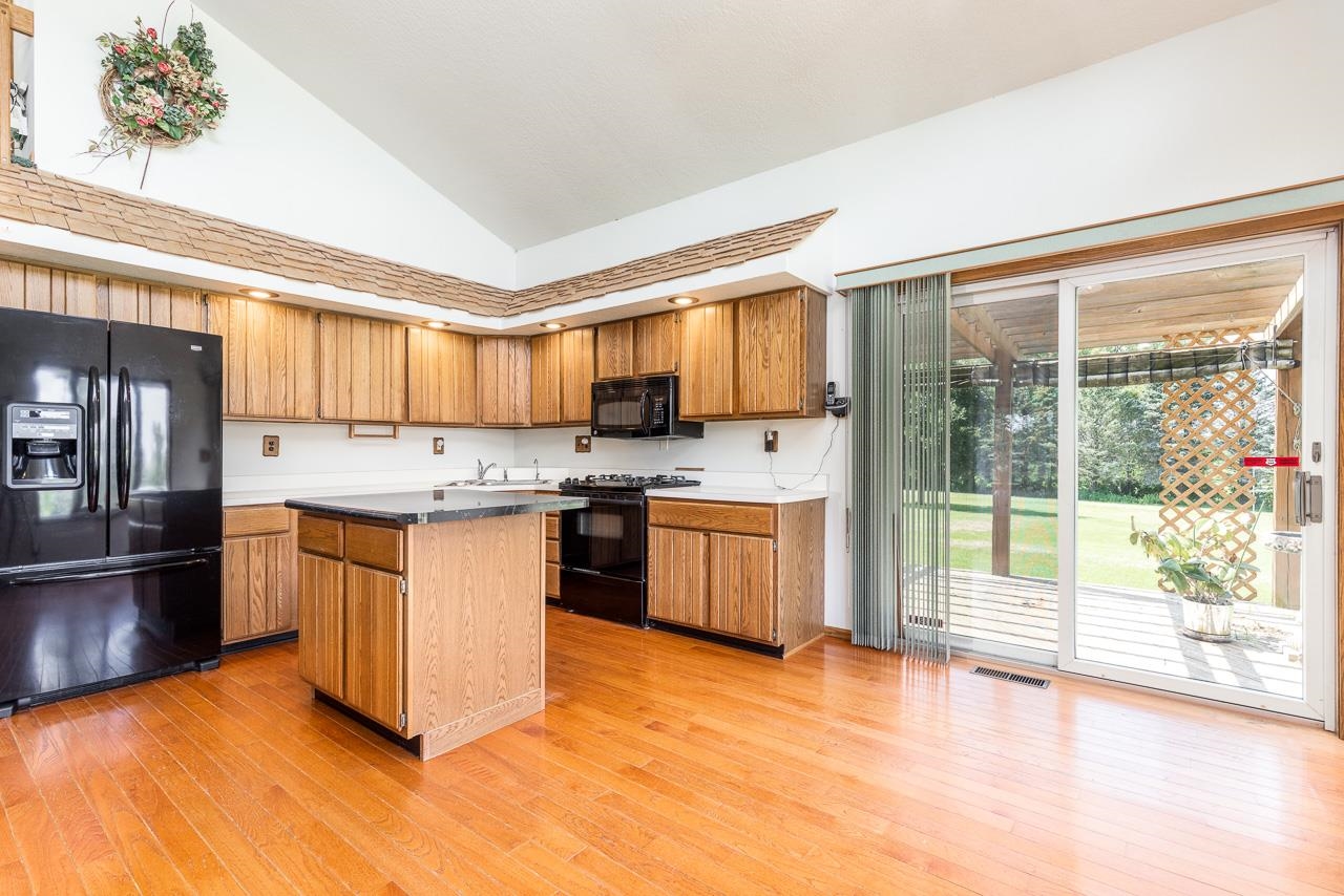 6418 Steward Road Rockford, IL 61101 - Photo 8 of 25 a kitchen with stainless steel appliances granite countertop a stove a sink and a refrigerator