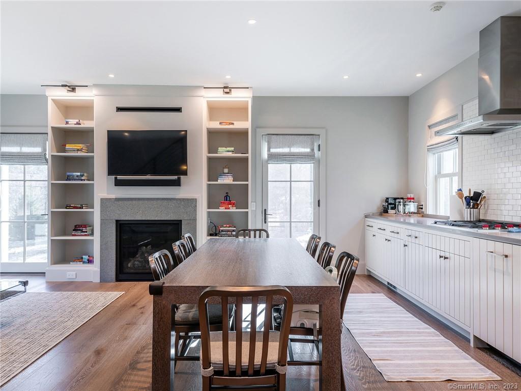 126 River Road Washington, CT 06794 - Photo 12 of 32 a kitchen with a dining table chairs and a fireplace